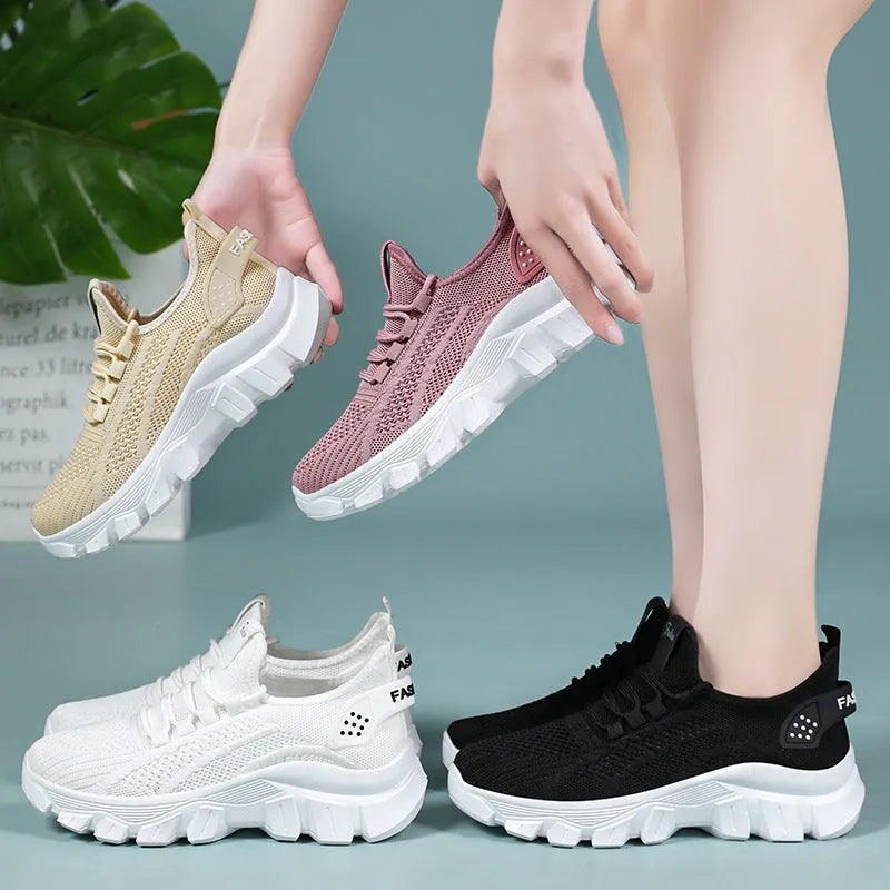 Women's white Flyknit running sneakers with thick PVC sole and lace-up front on a beige background.