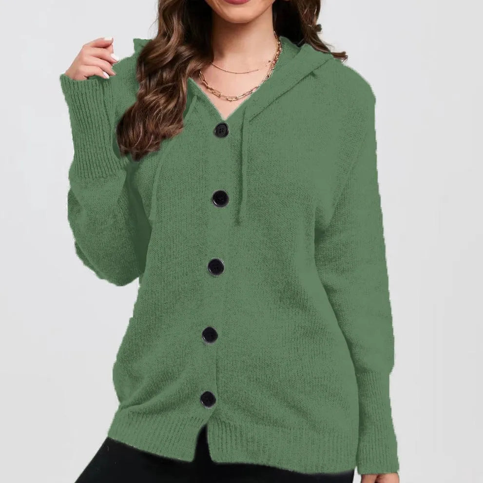 Woman wearing a loose-fit, thick cotton hooded cardigan sweater in a solid colour.