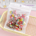 50 colourful cartoon mini erasers in fruit animal cake and seasonal designs measuring 1-1.5cm