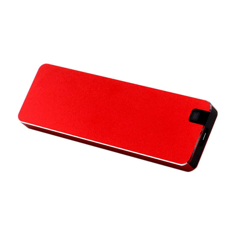 Compact silver portable solid state hard drive with USB cable on a dark surface