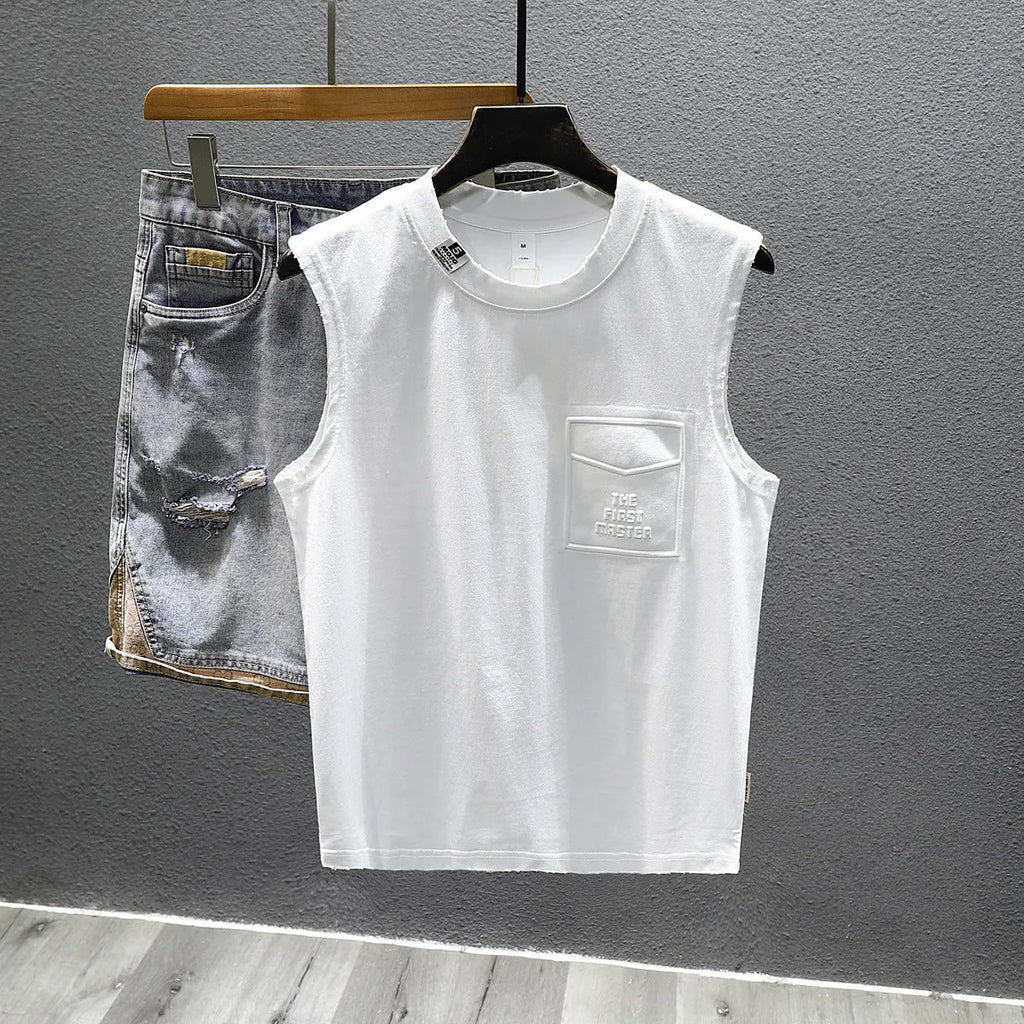 Loose fit solid colour cotton sleeveless t-shirt on a hanger, shown in white.