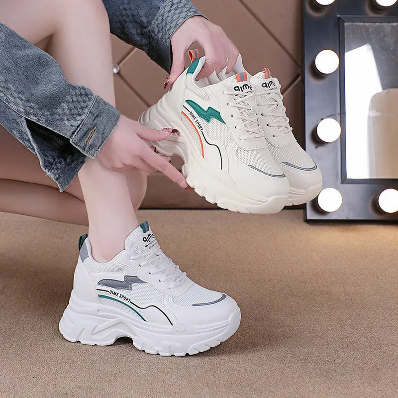 White women's dad shoes with cross shoulder straps and lace-up front on a rubber sole.