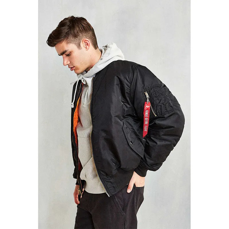 Men's army green American workwear style cotton-padded nylon jacket with a loose fit on a hanger.