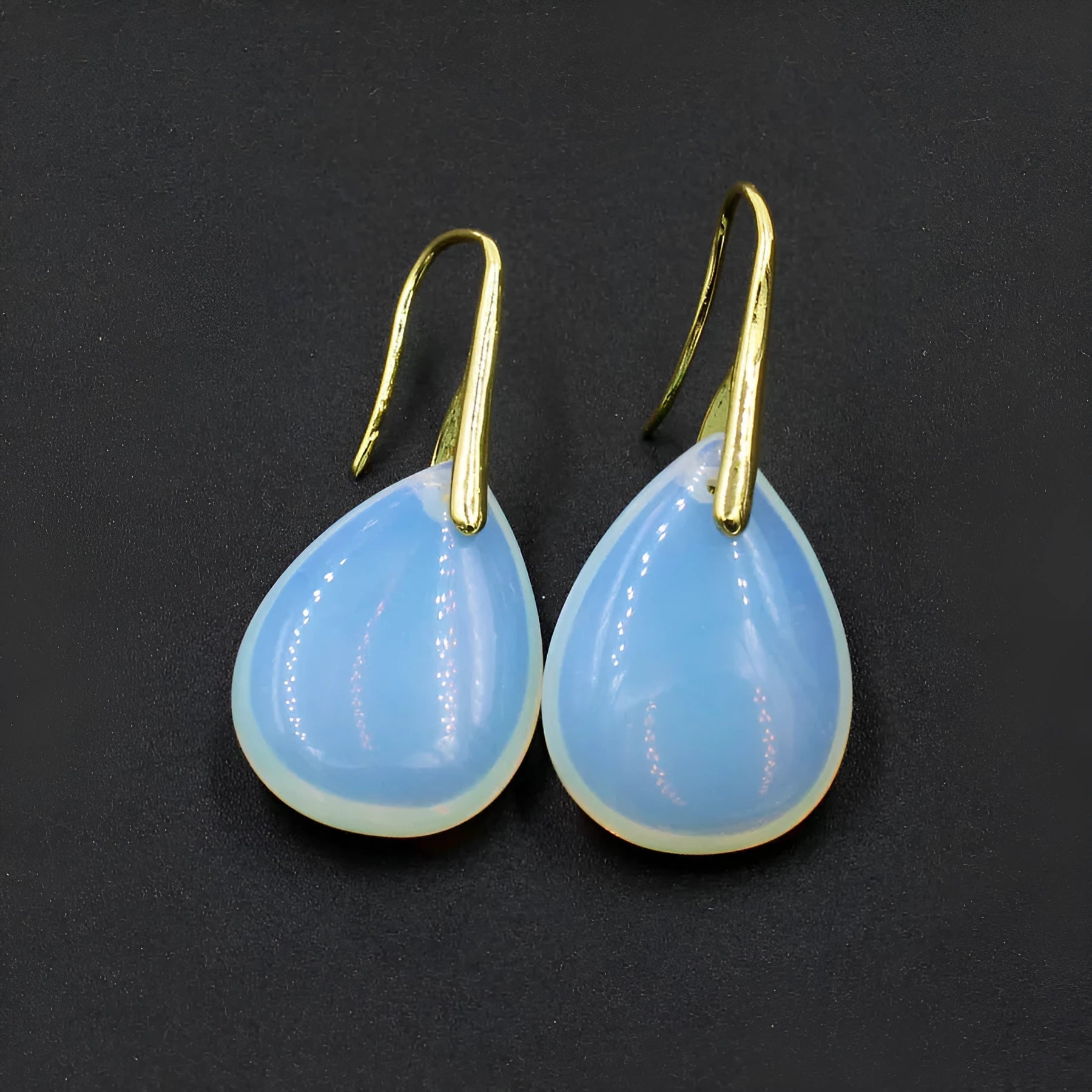 Geometric water drop earrings made from genuine crystal gemstones in various colours with electroplated metal components