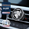 Silver magnetic car phone holder mounted on vehicle air vent with smartphone attached