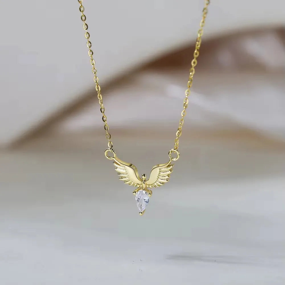 Women's eagle pendant silver necklace with O-ring chain on a grey background.