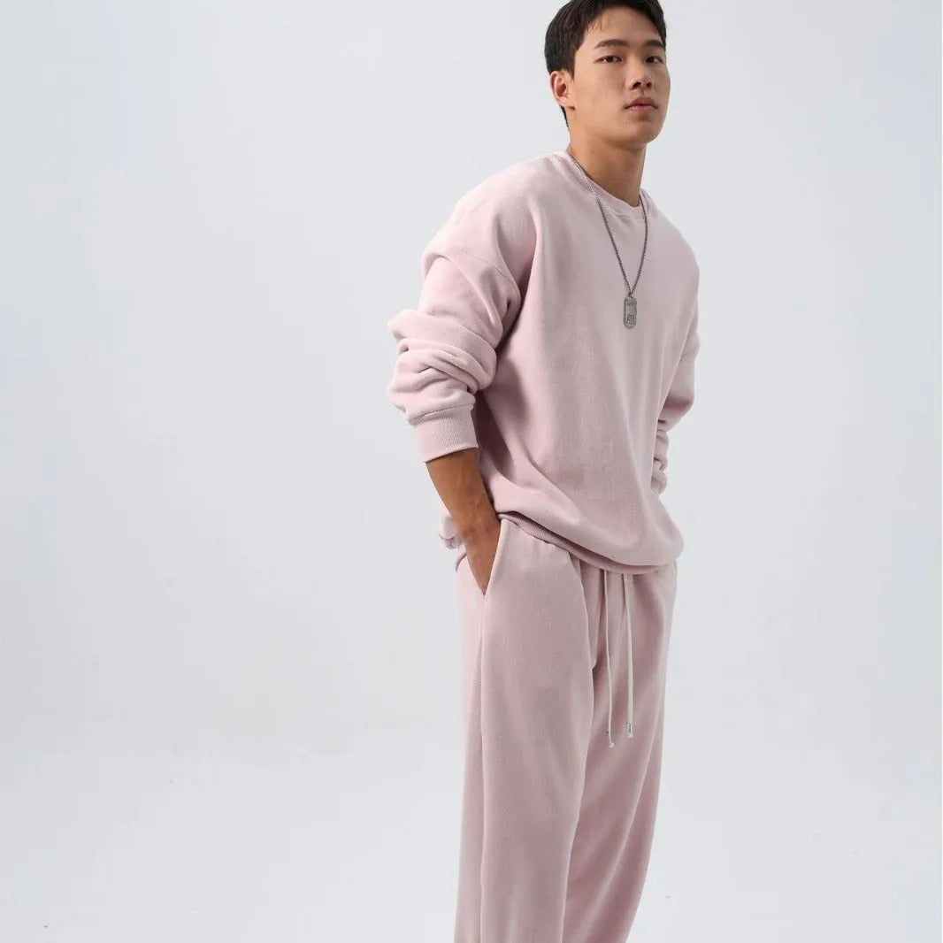 Men's polar fleece sports suit showing loose long sleeve coat and padded trousers in army green.