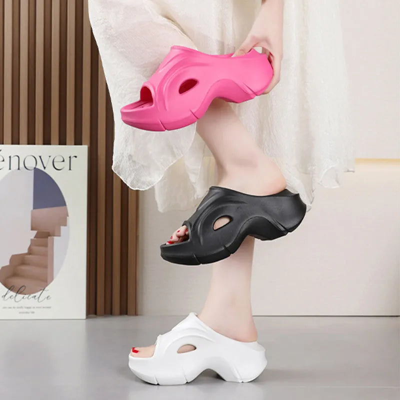 Women's thick-soled EVA beach slippers in rose red colour on a sandy background