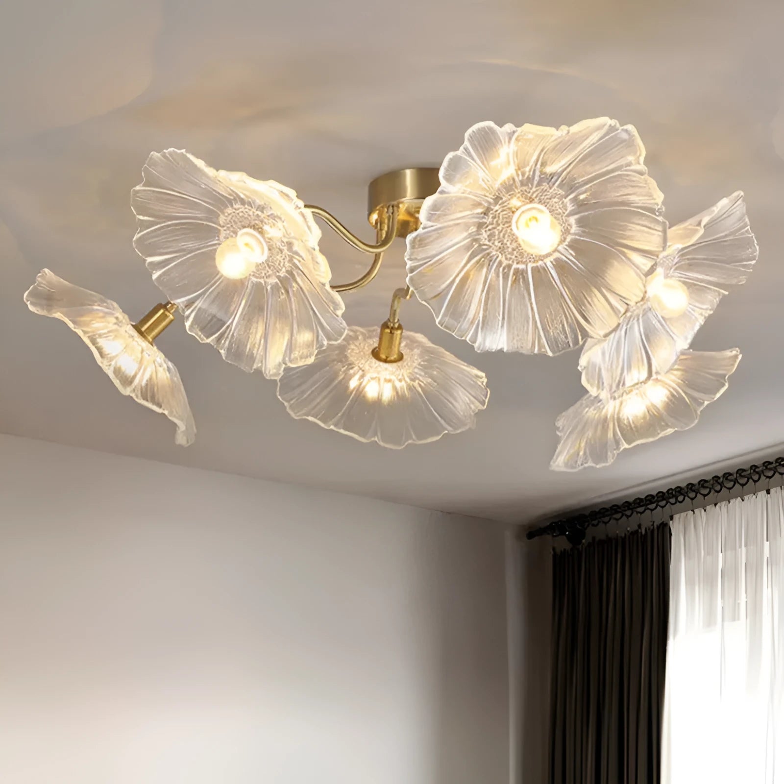 White flower pendant ceiling lamp with five flower heads emitting warm light in modern bedroom