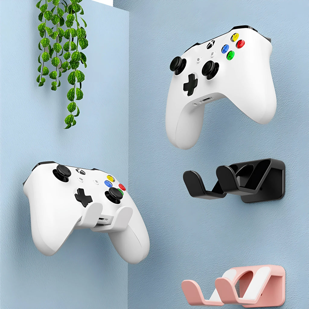Black ABS plastic universal wall hanging rack for game controllers and headphones with adhesive glue.