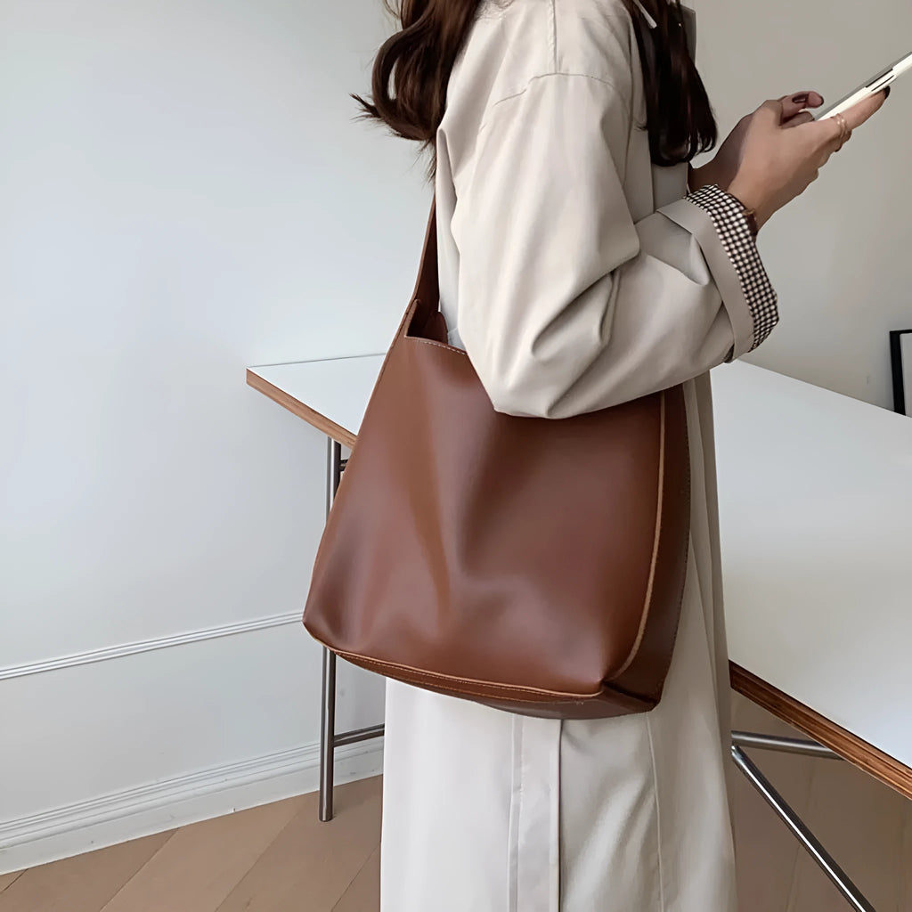 Women's soft PU shoulder bag with swing threads detail in black or brown colour