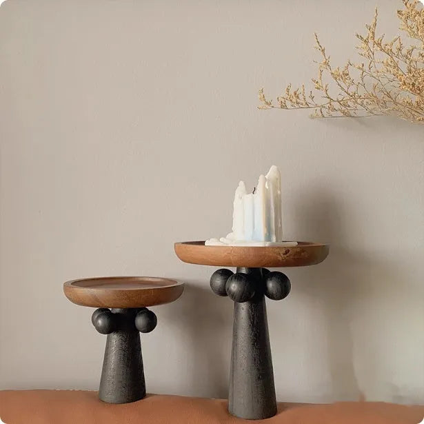 Nordic style high-legged round wooden tray on a table.