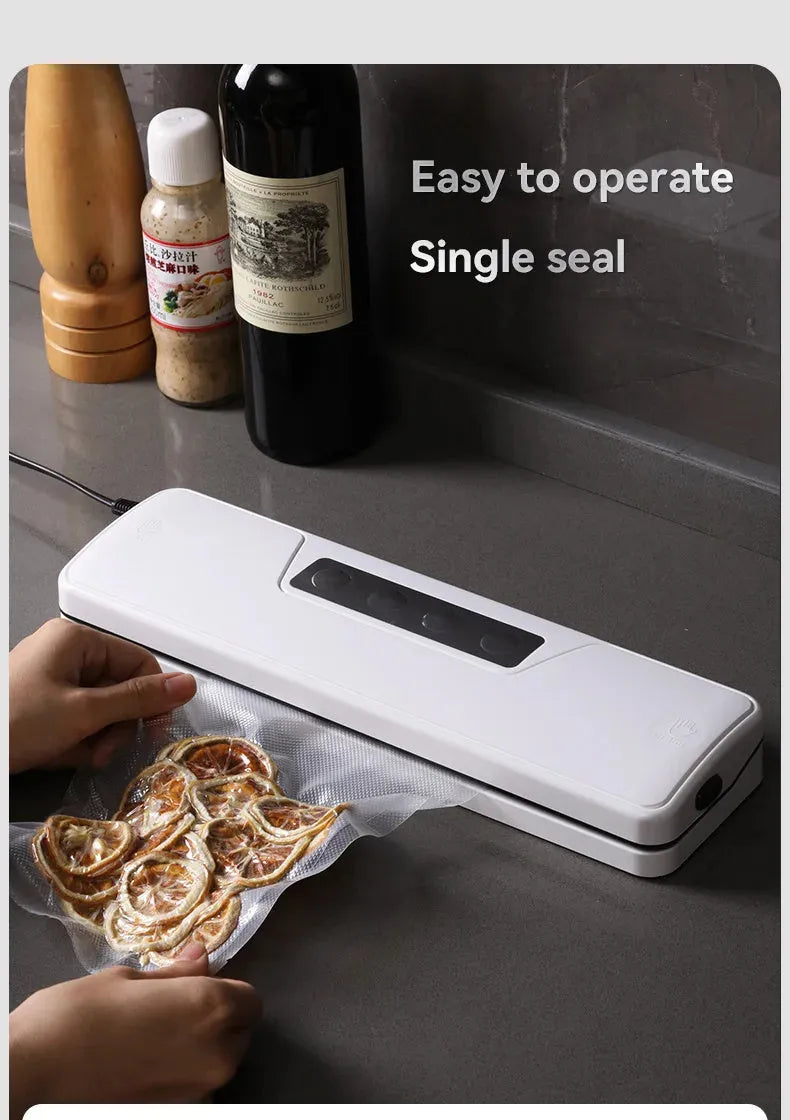 Small white automatic vacuum sealing machine for home food preservation on a kitchen counter.