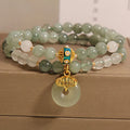 Women's green double-layer crystal bracelet with a peace buckle clasp and rhinestone details.
