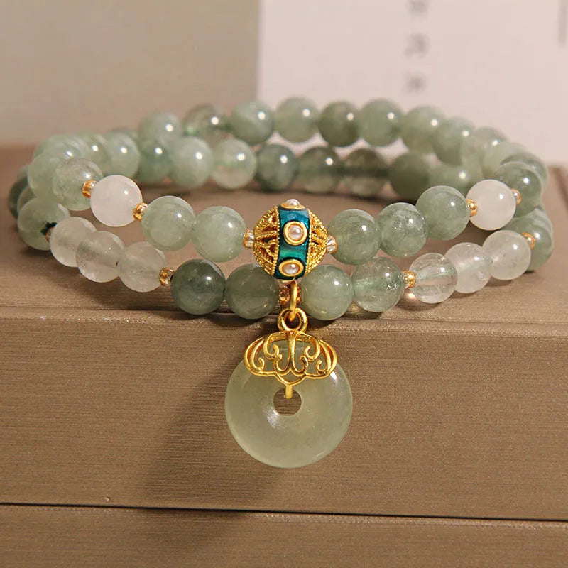 Women's green double-layer crystal bracelet with a peace buckle clasp and rhinestone details.