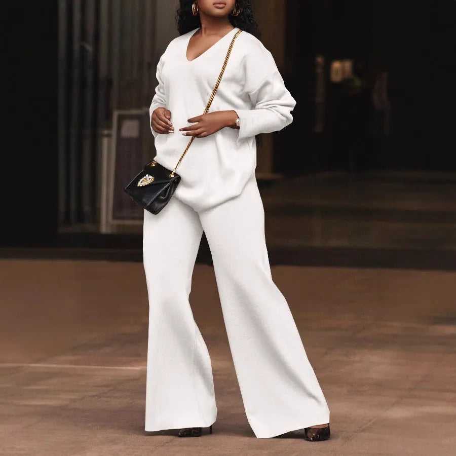 Brown women's suede velvet two-piece suit with long sleeves and full-length trousers on a model.