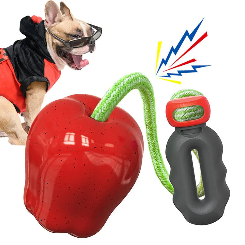 Green and red plastic apple-shaped dog toy with treat-dispensing ball and squeaky features