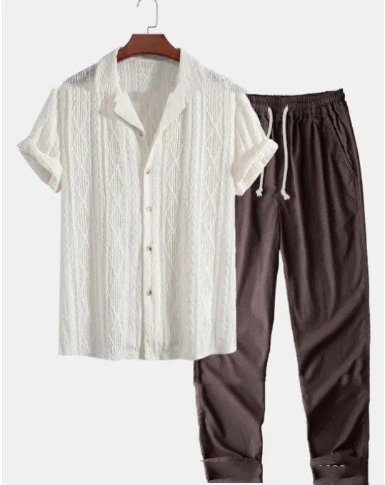 Man wearing a loose light blue short sleeve shirt and matching trousers, a milk silk casual summer suit.