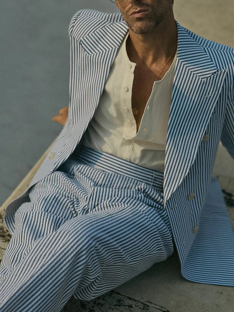 Men's blue and white striped polyester suit set with regular fit blazer and trousers on a hanger.