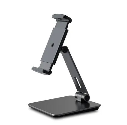 Silver foldable aluminium phone and tablet holder on a desk, showing 360-degree rotation feature.