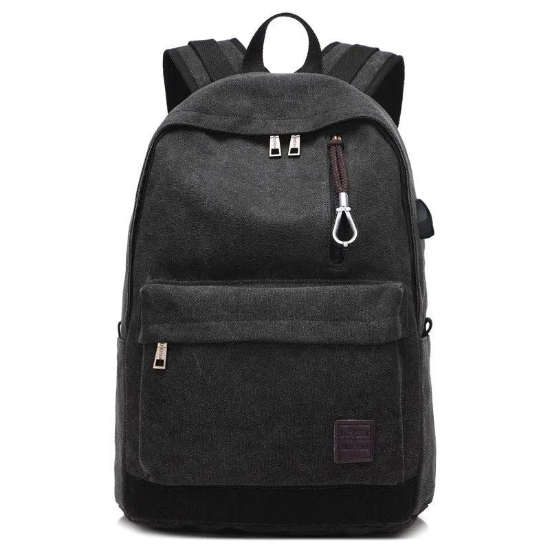 Canvas backpack in grey colour showing USB charging port, front zipper pocket, and adjustable shoulder straps