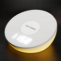 White wireless charging pad with clock display and alarm functions for smartphone bedside charging