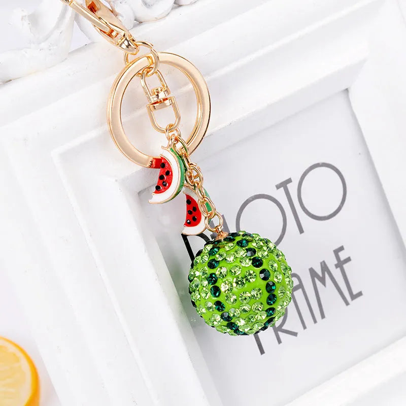 Green watermelon shaped zinc alloy keychain measuring 12cm in length