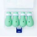 Four green silicone foot covers for protecting hands from cat scratches during pet care.