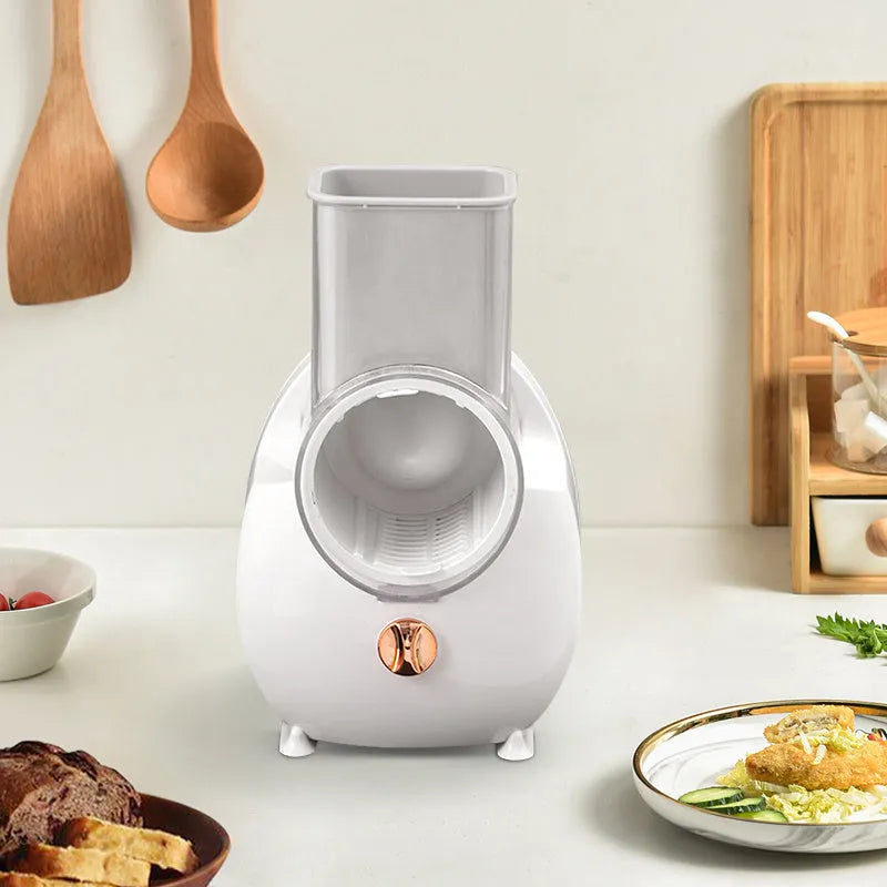 White electric vegetable slicer with suction base and interchangeable blades for automatic cutting