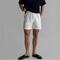 Men's loose fit cotton sports shorts in black colour on a hanger