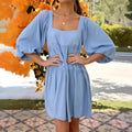 Girls orange backless dress with puff sleeves and a square collar, showing A-line skirt.