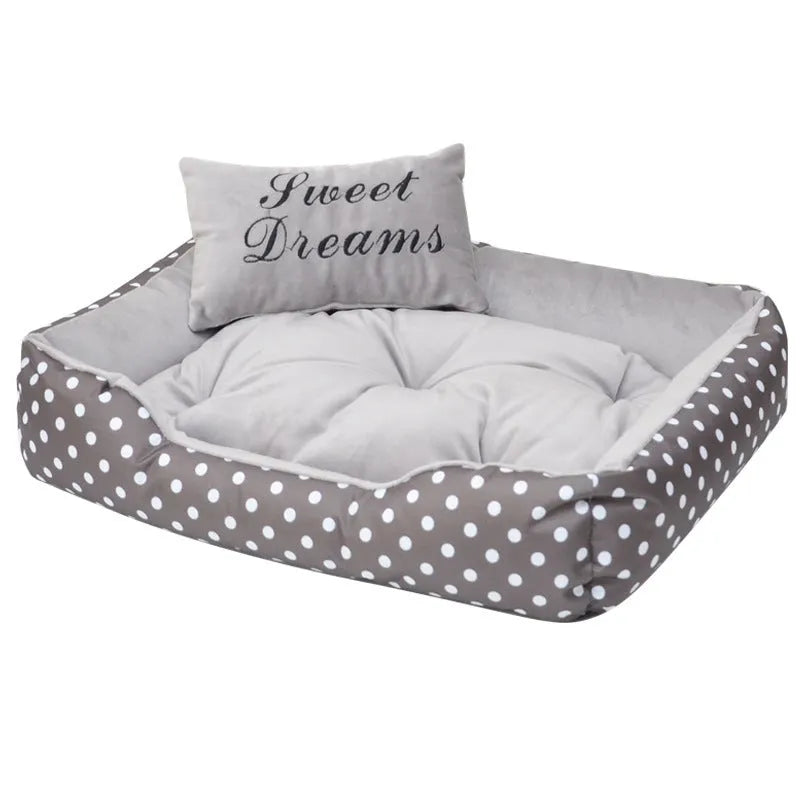 Polka dot printed cloth dog bed with matching embroidery pillow in grey, shown in a room setting.