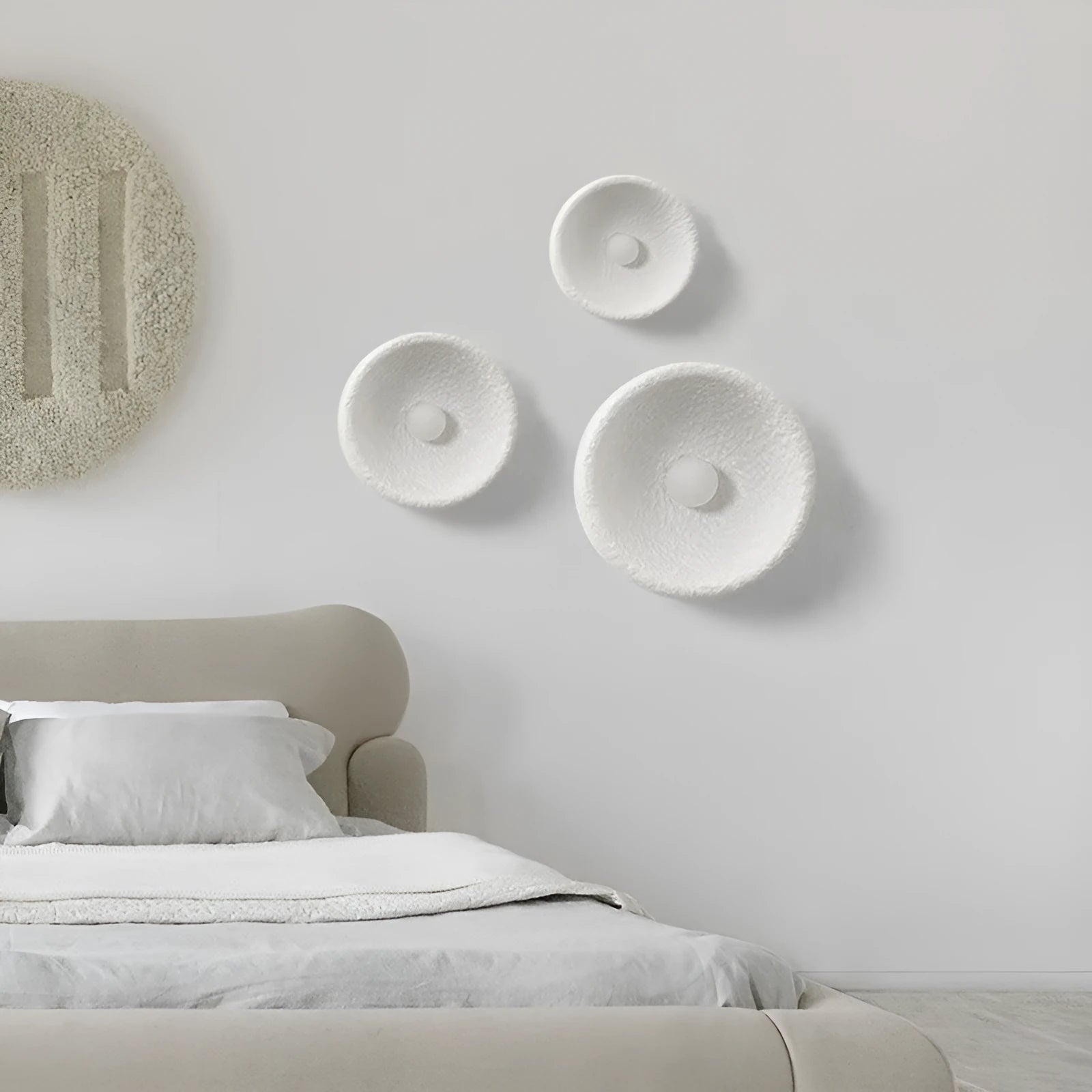 Japanese minimalist wall lamp in resin with warm light, showing three size options