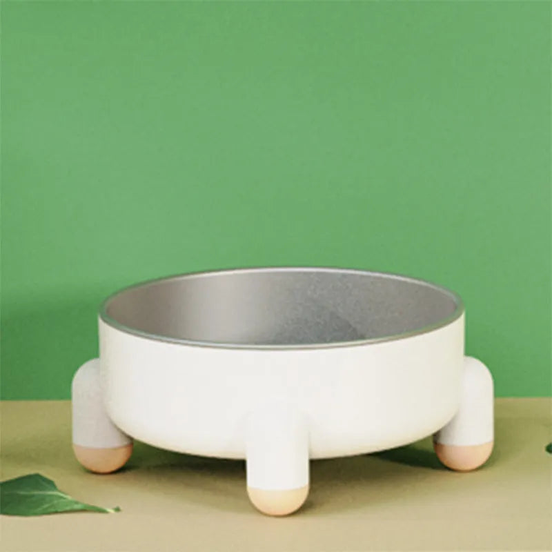 Green non-slip stainless steel pet food bowl with a high foot, shown on a floor.
