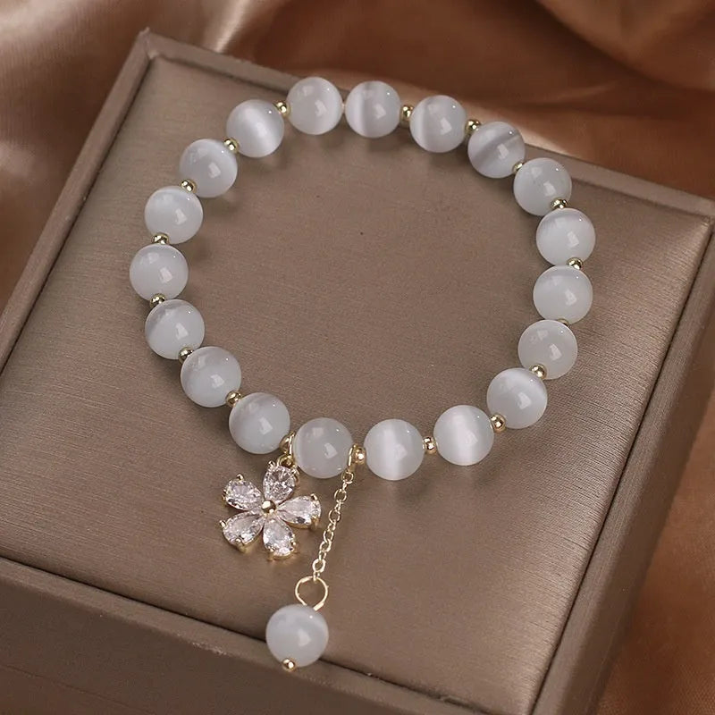 White Cat's Eye stone bracelet with flower tassel and morganite safety buckle.