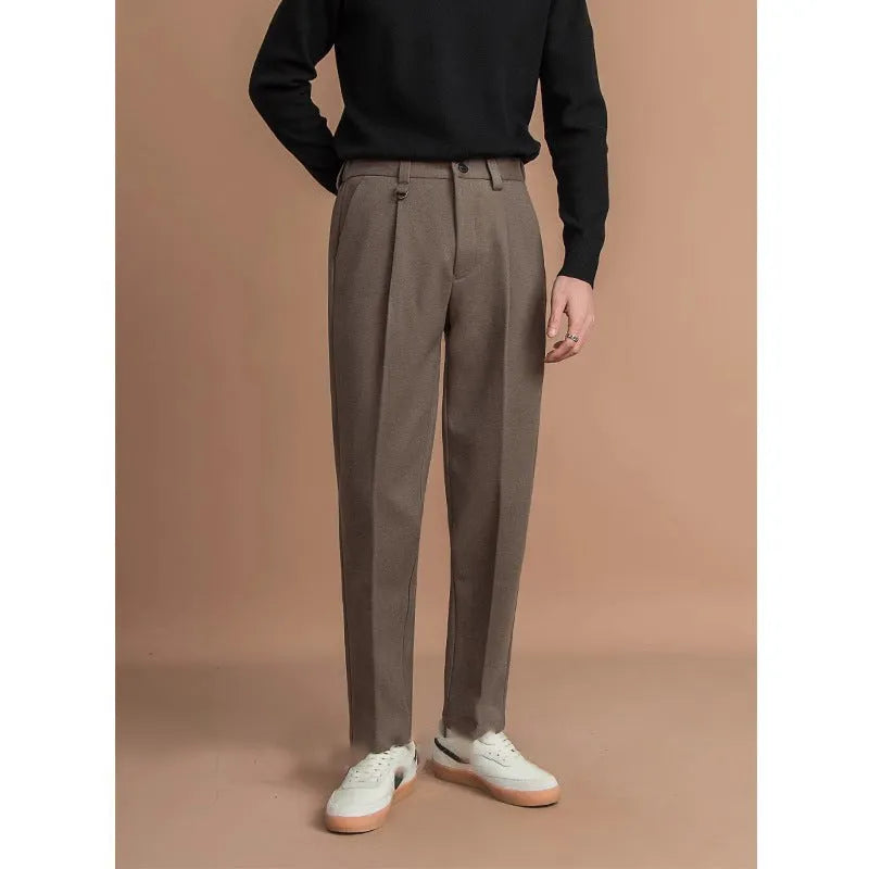 Men's straight leg casual pants in black with a draped fit, shown on a hanger.