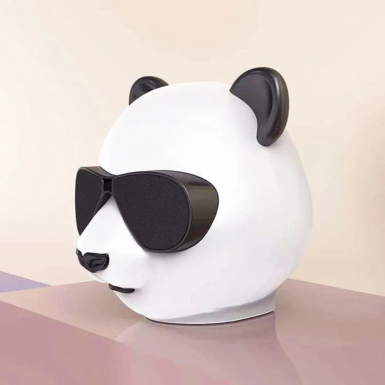 Portable mini Bluetooth speaker in classic style, showing front grill and likely a USB port.