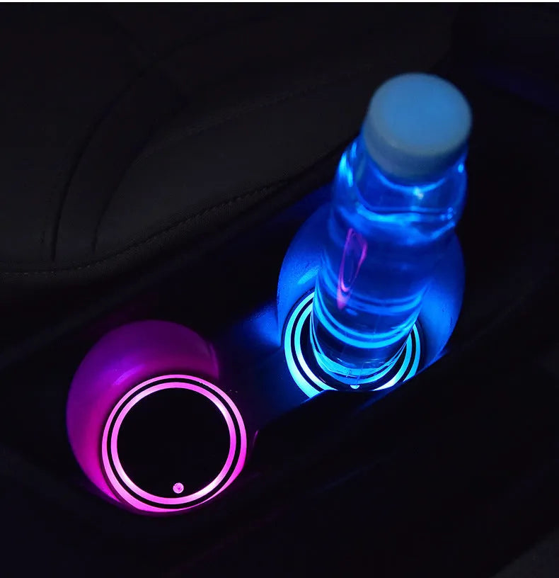 Colourful LED light-up coaster for car cup holders showing seven colour options and USB charging cable