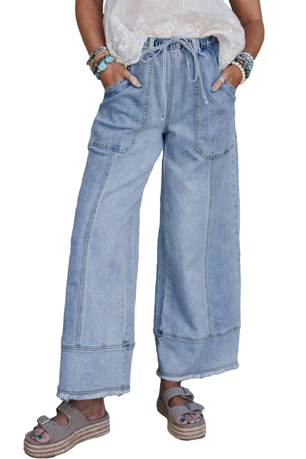 Beau blue wide leg denim trousers with a drawstring waist and raw hem detailing.