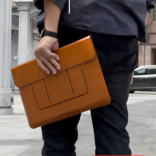 Brown plastic dual-angle laptop bag bracket holding a 13.3-inch laptop sleeve on a desk.