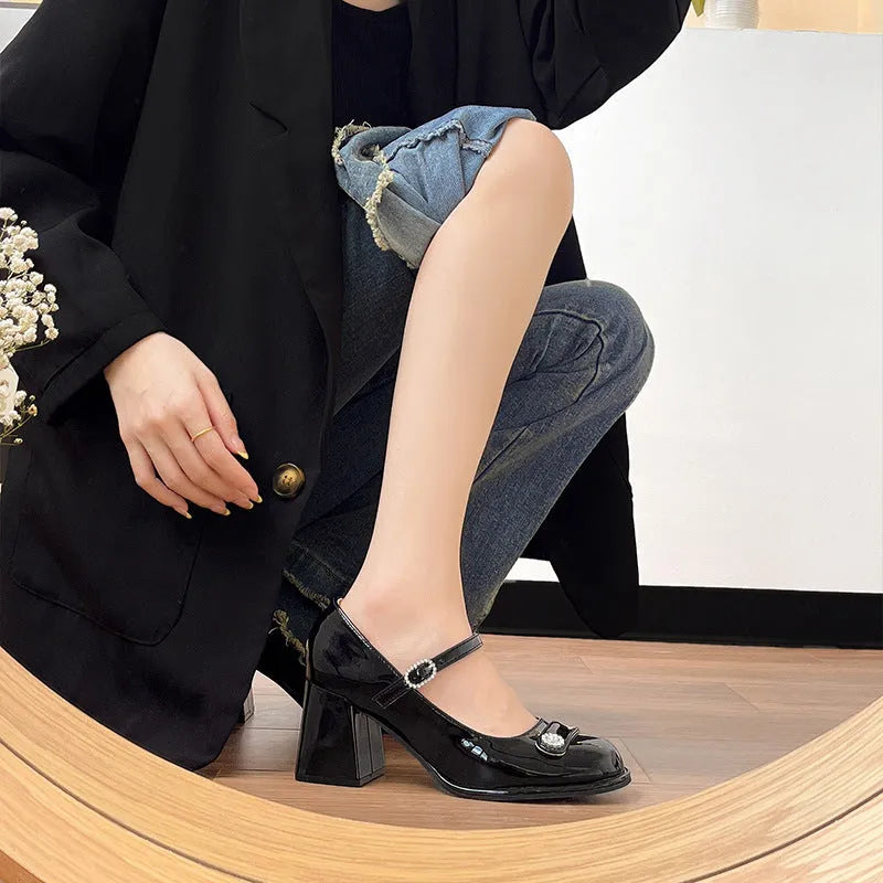 Women's black patent leather chunky heel shoes with round toe and buckle fastening