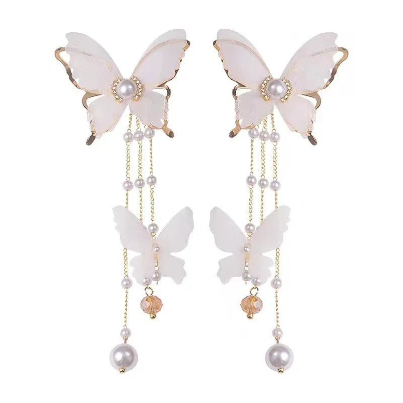 White butterfly earrings with tassel lace design featuring rhinestones and pearls