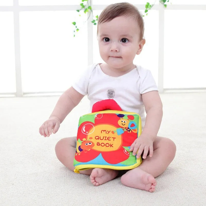 Multi-functional soft cloth baby book with zip and carry handle, 18.5cm wide by 20cm high, 12 pages.