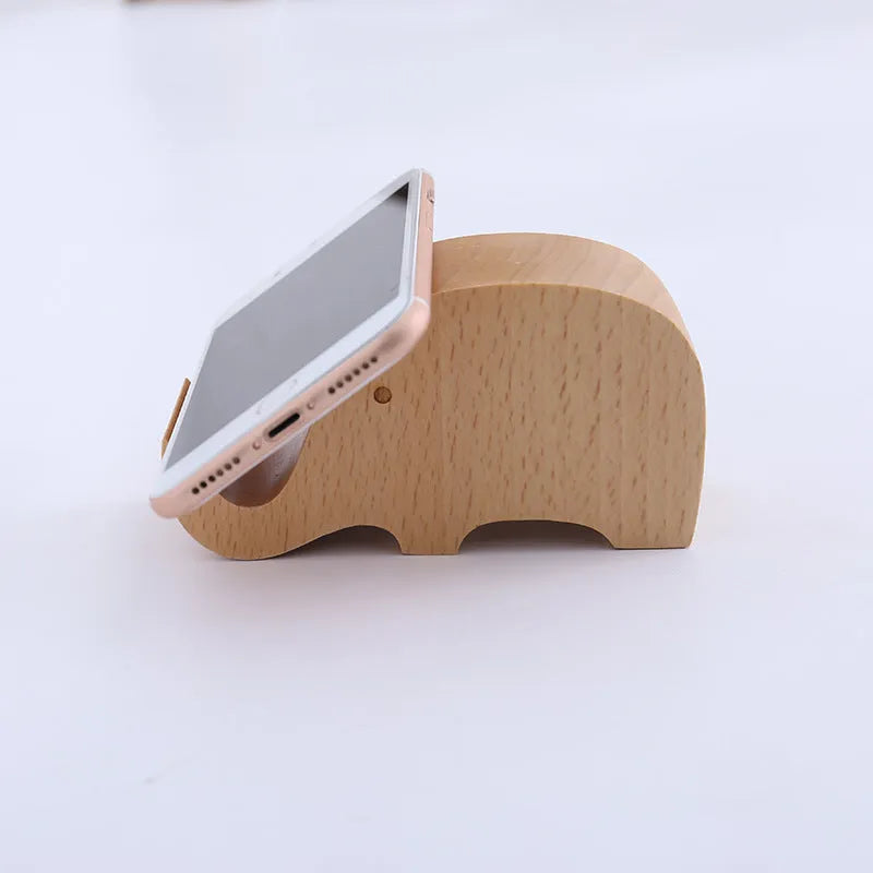 Solid beech wood mobile phone stand with a decorative resin animal ornament and a coin slot.