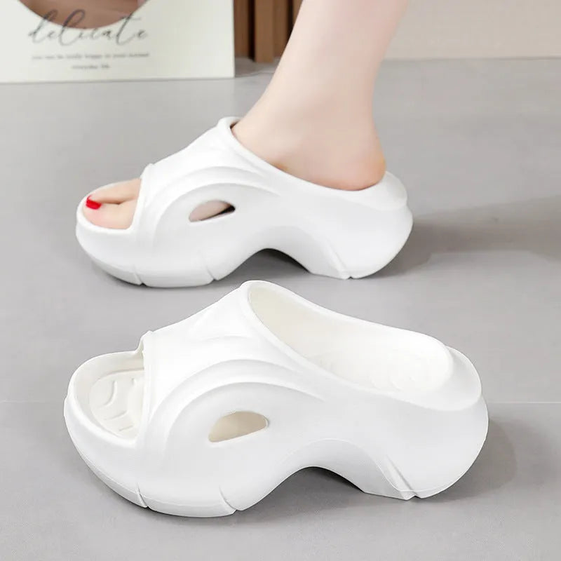 Women's thick-soled EVA beach slippers in rose red colour on a sandy background