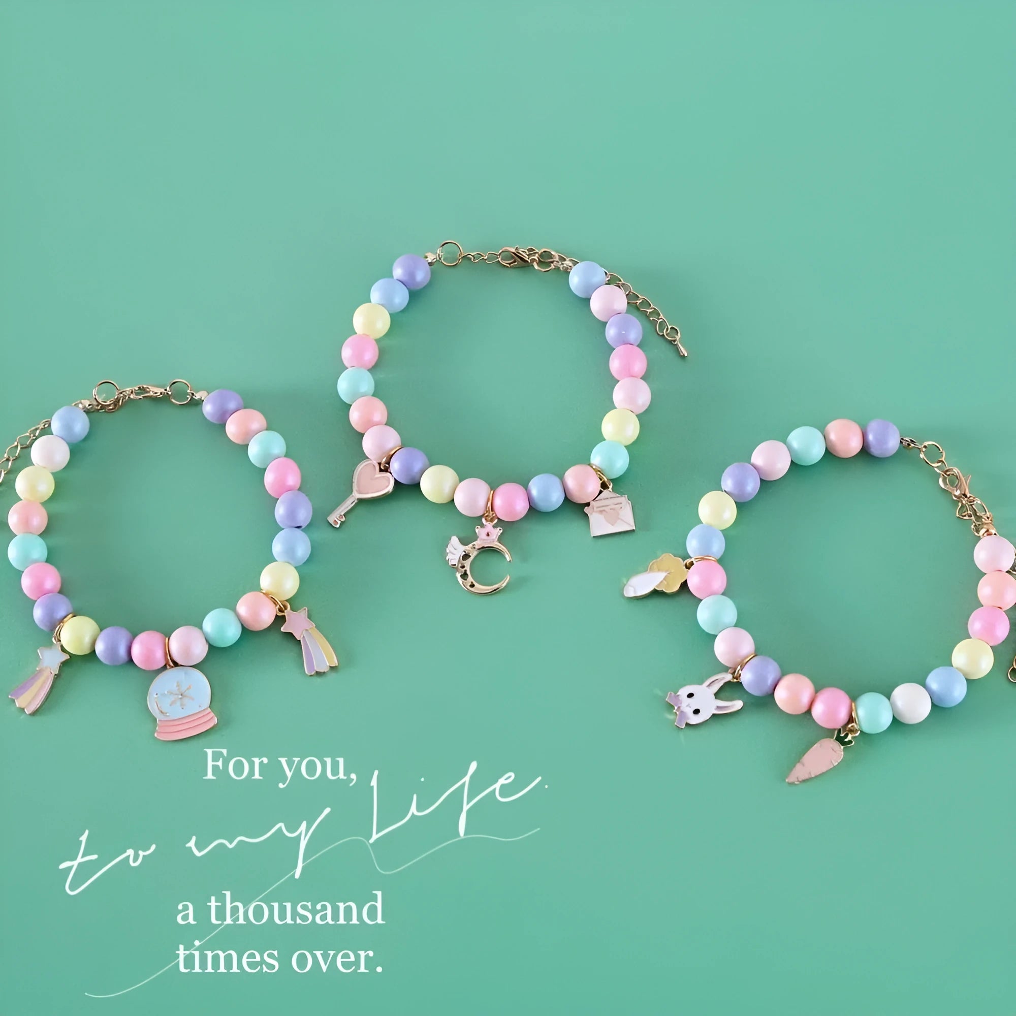 Colourful macaron-themed resin pet collar and matching bracelet set on a table.