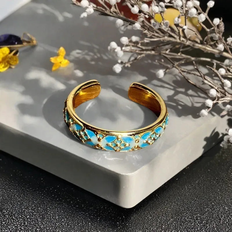 Adjustable copper ring featuring a gourd, flower, and bow design with zircon inlay in New Chinese style.