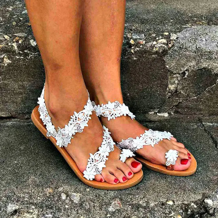 White women's flat shoes with rhinestone and floral pattern on patent PU upper, round toe, low back.