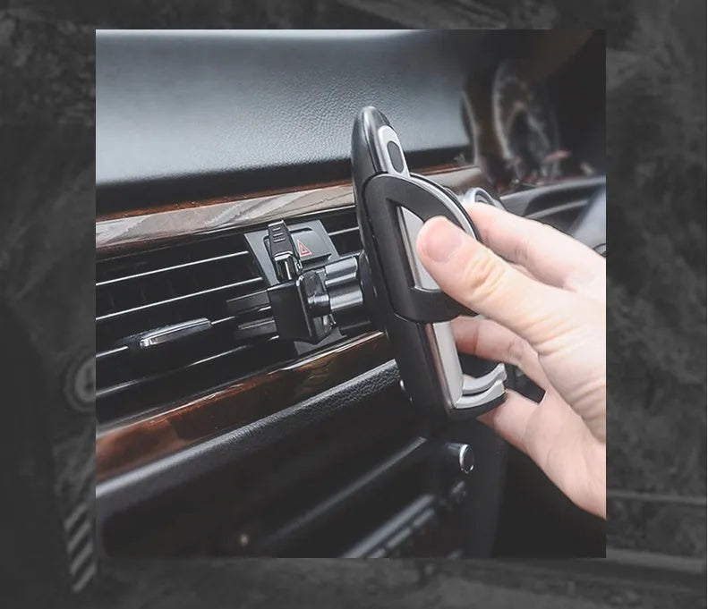 Black plastic car air conditioning vent mobile phone holder showing adjustable clamp for universal device mounting.