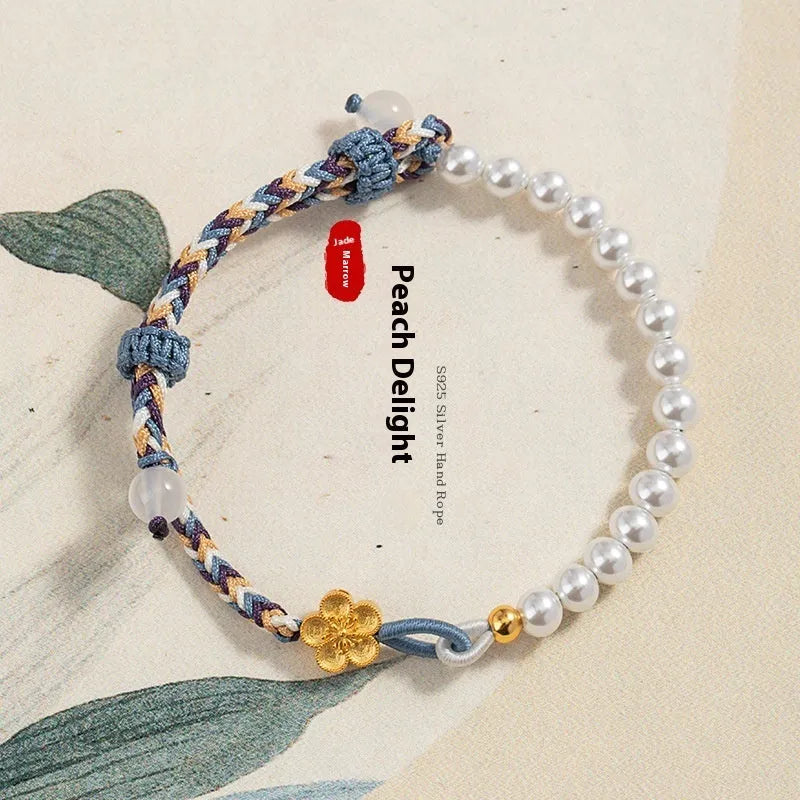 Peach coloured cord carrying strap with electroplated sterling silver chalcedony bead and Chinese flower weaving design